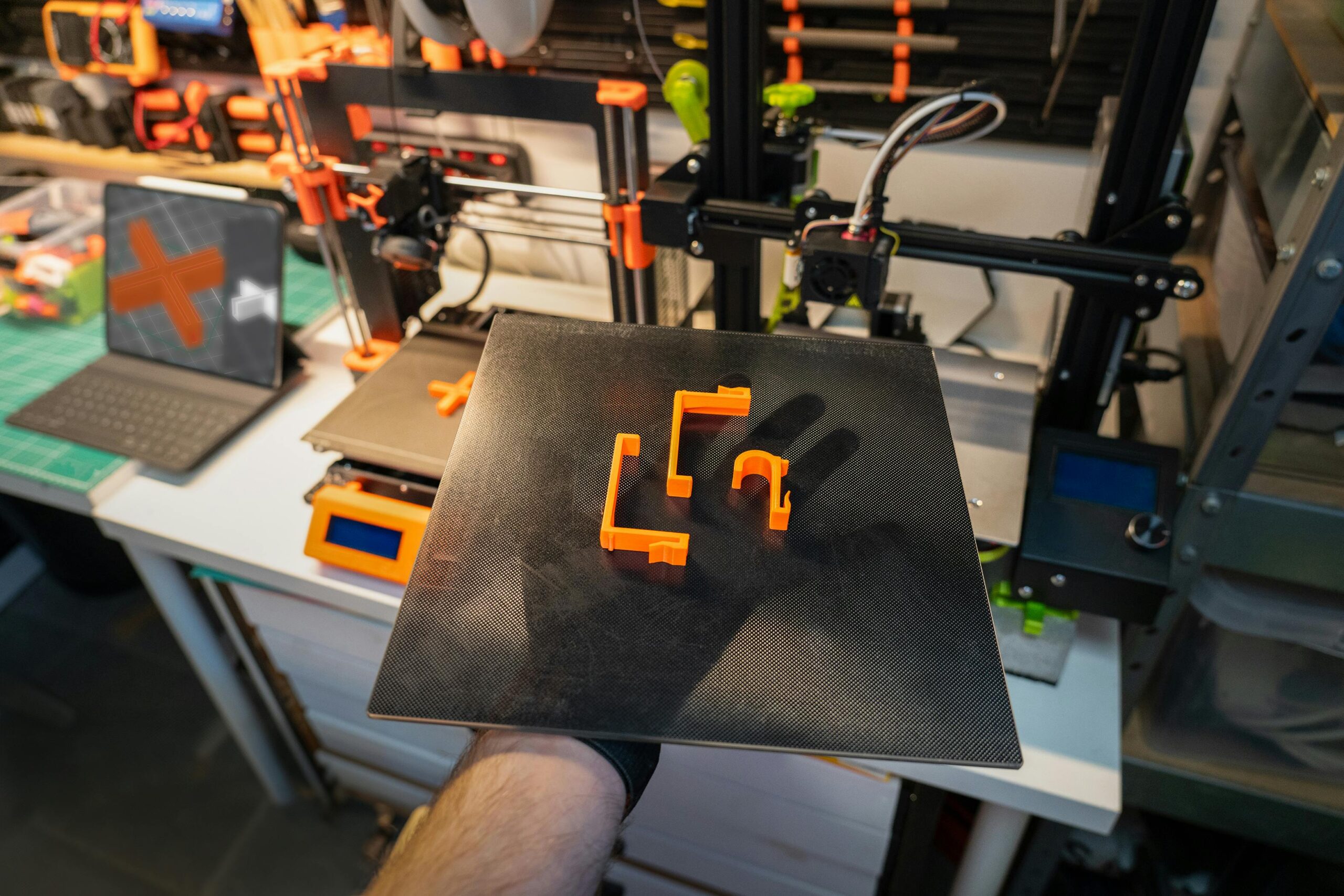 man holding a tray with plastic 3d printed items